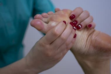 foot massage with oil is being provided to a person in a massage centre in Islamabad